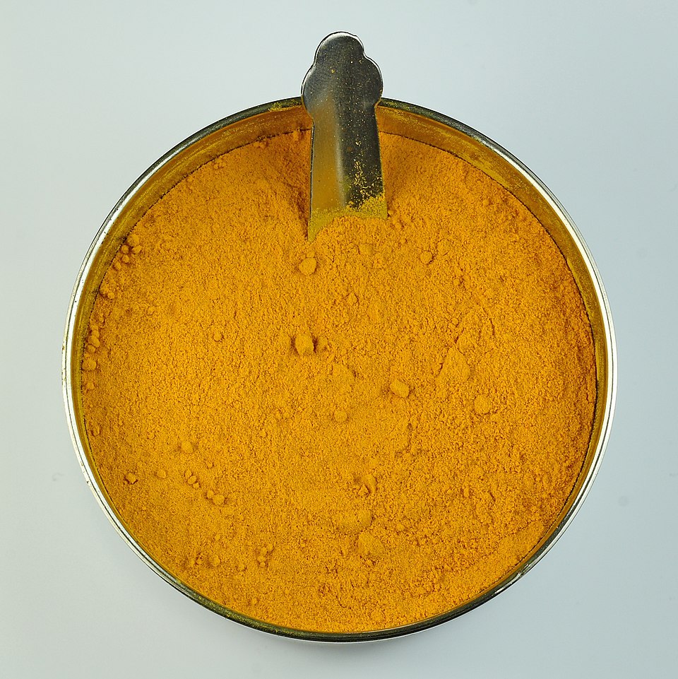 Assortment of dried Ayurvedic herbs on a wooden surface