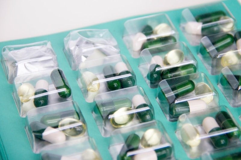 Assorted pills and capsules on surface