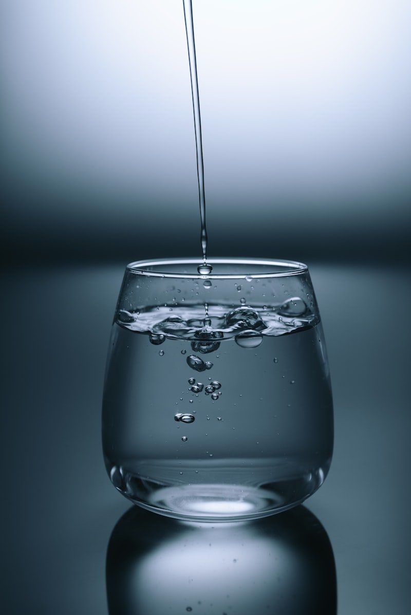Person drinking water representing hydration and food safety